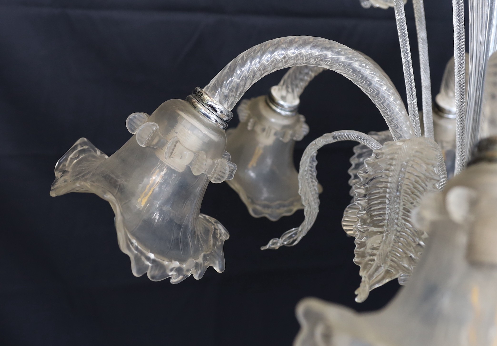 A Venetian clear glass six light chandelier with ornate foliage and flower motifs, height 85cm. width 74cm